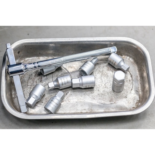 STANLEY STHT81581-0 socket set with ratchet handle in silver tray, close-up photography.