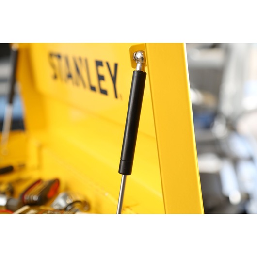 STANLEY STMT1-75062 yellow tool chest gas strut close-up, tools visible inside, side angle.