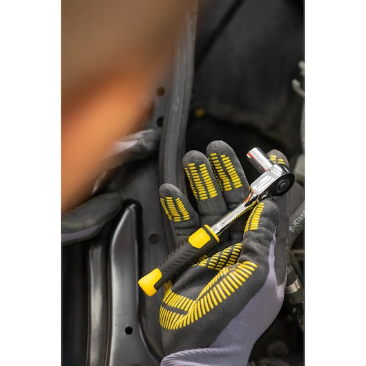 Photo of STANLEY STMT82829-1 ratchet wrench held in a gloved hand, featuring a black and yellow handle.