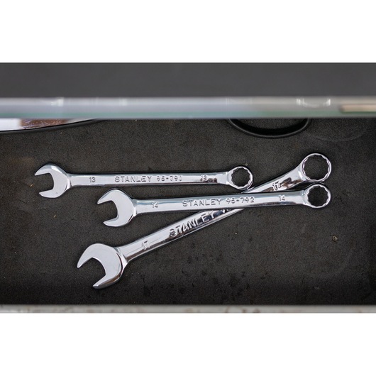 Photo of STANLEY STMT82842-0 combination wrenches set on dark foam surface, top view.