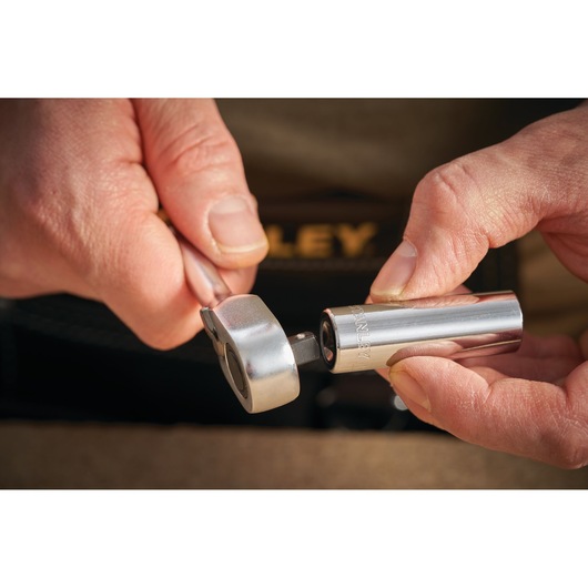 STANLEY STMT86096-0 chrome socket and ratchet held in hands, close-up photography.
