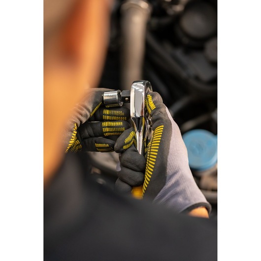 STANLEY STMT86508-0 ratchet being used by gloved hands, automotive maintenance setting.
