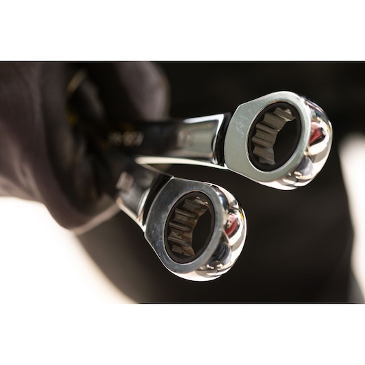STANLEY STMT89913-0 ratcheting wrenches held in gloved hand, close-up photography of tool heads.