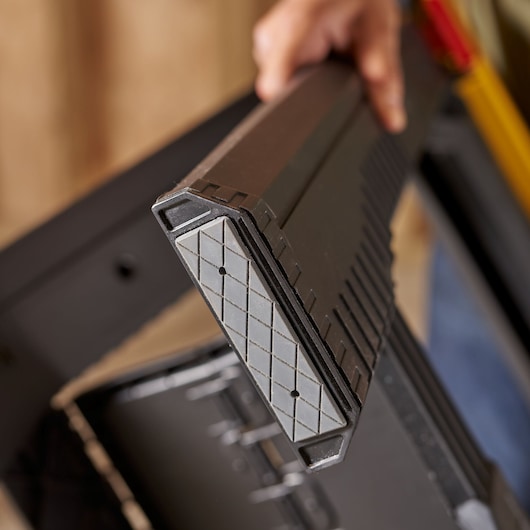 STANLEY STST1-70559 saw horse close-up, showing gray anti-slip end, photography of product in use.
