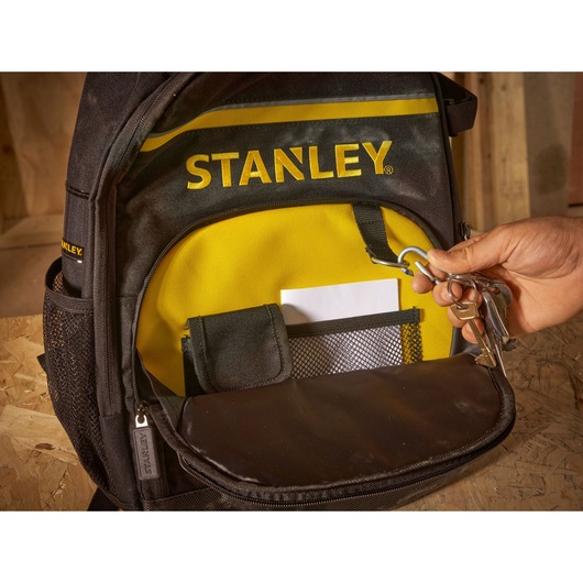 STANLEY STST1-72335 backpack front pocket with key holder, mesh pouch and yellow lining, close-up photo