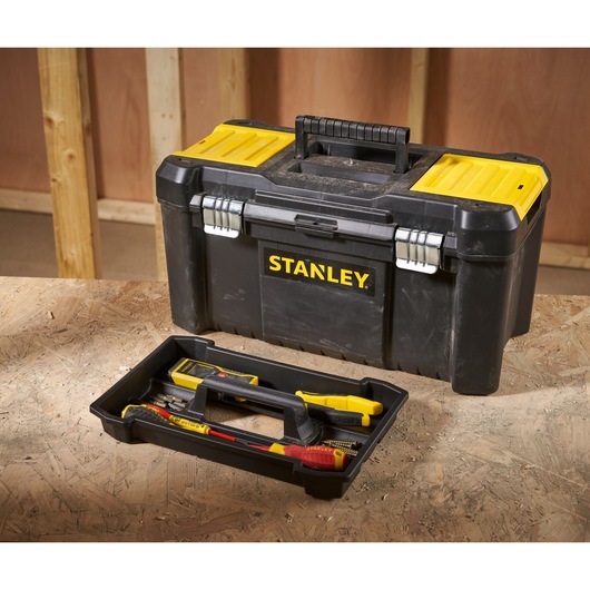 STANLEY STST1-75521 black and yellow toolbox with tray and tools, shown on a workshop table.