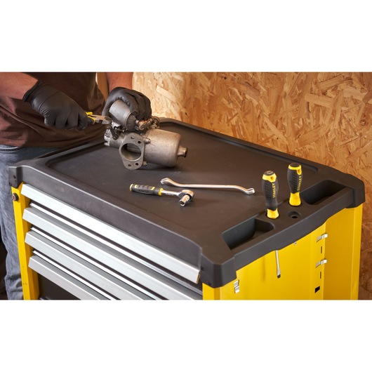 STANLEY STST74305-1 tool chest top with STANLEY hand tools and parts, photographed from above in workshop setting.