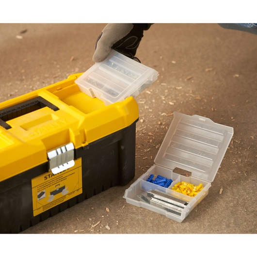 STANLEY STST75785-1 toolbox with open plastic organizer containing screws and wall plugs, close-up.