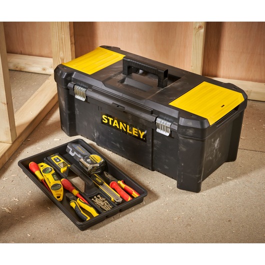 STANLEY STST82976-1 black and yellow toolbox with tray of hand tools on workshop floor.